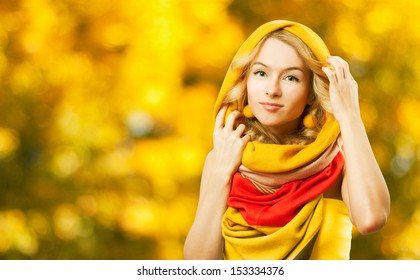 Blonde Woman Wearing Colorful Infinity Scarf. Autumn Fashion.