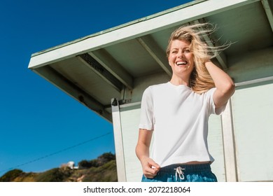 Blonde Woman In White Tee At The Beach