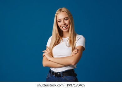 Blonde Young Happy Woman Smiling And Looking At Camera Isolated Over Blue Background