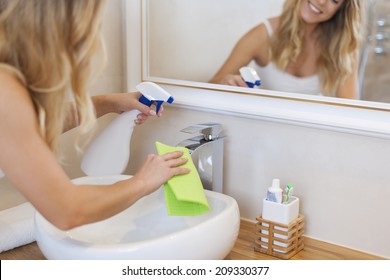 Blonde Young Woman Cleaning Bathroom