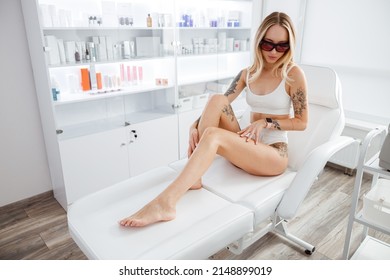 Blonde young woman sitting in daybed in beauty salon