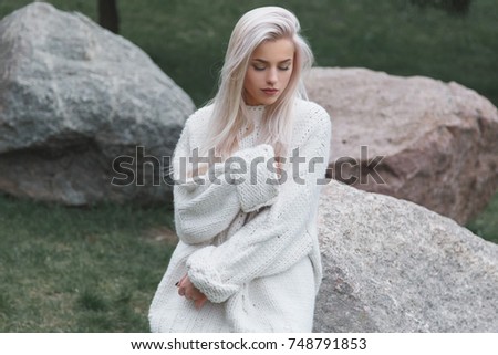 Blondhair beautiful female weared in knitted white sweater
