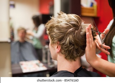 Blond-haired Man Having A Haircut With Scissors