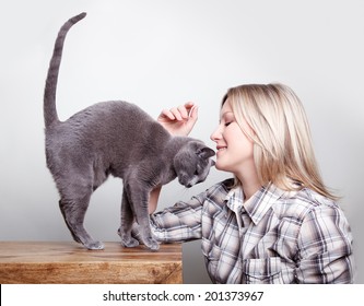 Blone Woman With Russian Blue Cat Showing Her Affection