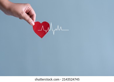 Blood Donation Or Heart Surgery Concept. Human Holding Small Piece Of Paper Blood Sign And A Red Heart Shape With  Heart Rate Beat.