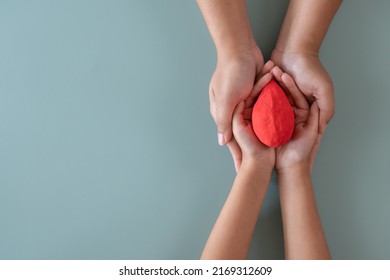 Blood Donation Or Medical Surgery Concept. Human Holding Small Piece Of Paper Blood Sign And A Red Heart Shape. Give Blood Save Lives.