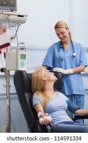 Blood Donor Sitting Next To A Nurse In Hospital Ward, Healthcare Workers In The Coronavirus Covid19 Pandemic