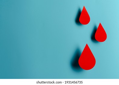 Blood drop symbol on blue background. Hemophilia day, blood donor day. Concept