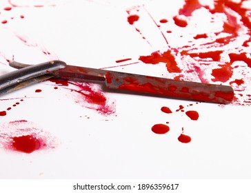 Blood drops. Murder and suicide concept. Blood trail and an old straight razor. An old razor and blood. Razor sharp and blood. 