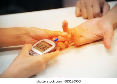 blood glucose meter with Diabetes mellitus pateint with scientist.