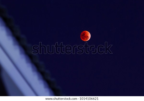 Blood Moon\
phenomenon on the roof of the\
house
