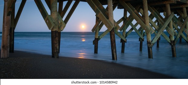 A "blood moon" rises over the Atlantic Ocean, at Wrightsville Beach, NC.