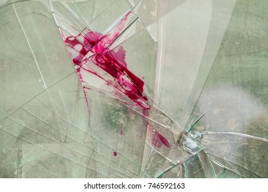 shattered glass on the floor with blood