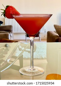 Blood Orange Martini Garnished With A Strawberry Is A Delicious Summertime Cocktail.