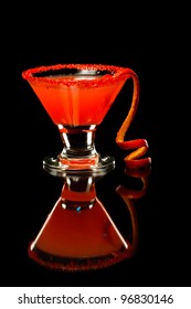 Blood Orange Martini With A Long Orange Twist Isolated On A Black Background