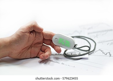 Blood Oxygen Meter On Mans Finger. Isolated On White Background.