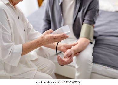 Blood Pressure. Aged Woman Helping Her Sick Husband To Check Blood Pressure