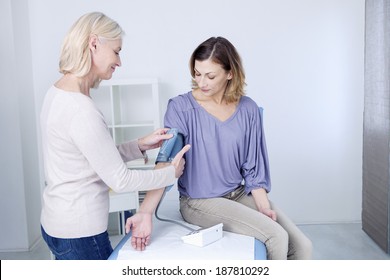 Blood Pressure Being Taken Of Middle Aged Woman