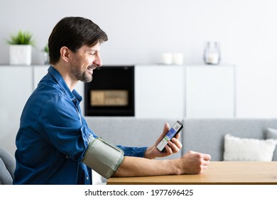 Blood Pressure Check Using Smart Monitor. African Patient Man