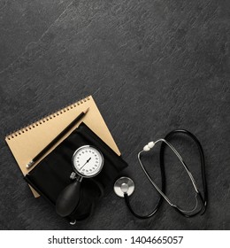 Blood Pressure Meter And Stethoscope From Above On Dark Stone Background With Notebook And Pencil With Space For Notes, - Bilder