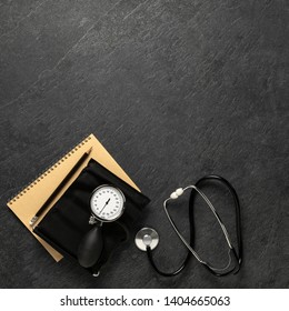 Blood Pressure Meter And Stethoscope From Above On Dark Stone Background With Notebook And Pencil With Space For Notes, - Bilder