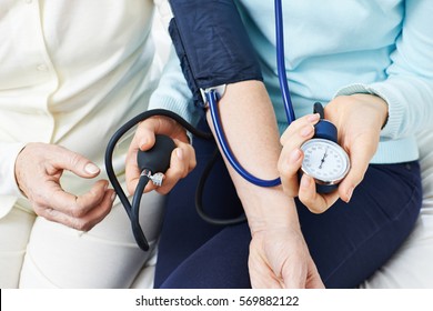 Blood Pressure Monitoring On Arm Of Senior Woman