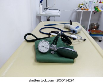 Blood Pressure Tonometer Close Up On Medical Table In Exam Room In Emergency Hospital. Medical Equipment For Diagnosis. Health Care