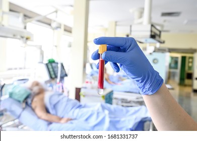 Blood Sample Test Tube In Hands Of Intensive Care Unit Nurse. Corona Virus Outbreake Image.