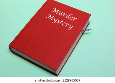 A Blood Stained Dagger Used As A Book Mark In A Murder Mystery Novel.