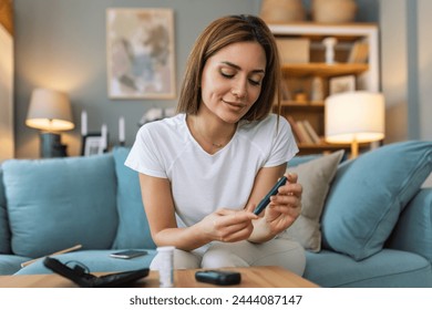 Blood sugar testing at home. Checking Blood Sugar Level At Home. Diabetic Checking Blood Sugar Levels. Woman checking blood sugar level by glucometer and test stripe at home