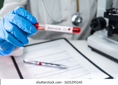 Blood Test Tube In Doctor Hand, Mers-CoV Coronavirus Test Positive Label In Hospital Blood Test Tube For Analysis. 2019-nCoV Virus Infection Originating In Wuhan, China