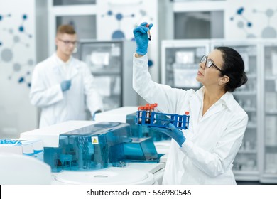 Blood Test Tubes. Senior Female Scientist Examining Blood Test Tubes At Her Laboratory Dna Testing Analysis Profession Specialist Clinician Experienced Medicine Healthcare Doctor Concept Copyspace 