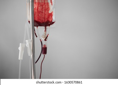 Blood Transfusion. Empty Bag On Stand. Blue Background With Copy Space