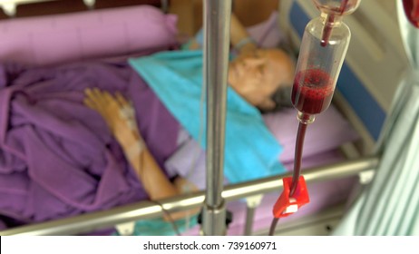 Blood Transfusion To Senior Woman Patient In Hospital Bed