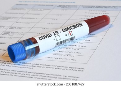 Blood tube for test detection of virus Covid-19 Omicron Variant with positive result on papers document.