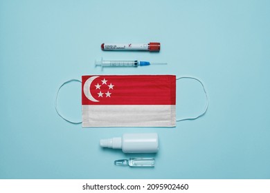 Blood Tube For Test Detection Of Virus Covid-19 Omicron Variant With Positive Result, Medicine Mask With Singapore Flag Superimposed And Vaccine.  New Variant Of The Covid-19 Omicron