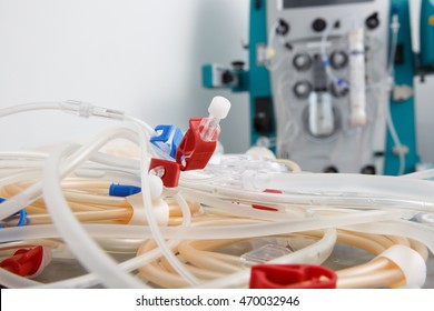 Bloodline tubes with hemodialysis machine in the background. Health care, blood purification, kidney failure, transplantation, medical equipment concept with copy space. 