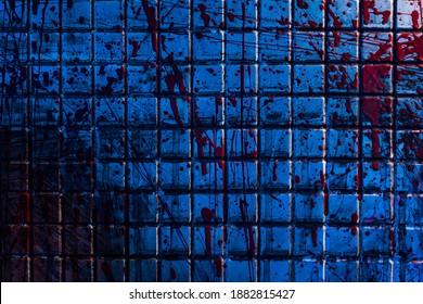 Bloody background. The dirty tile wall is stained with blood. A gloomy morgue room with a blue light.