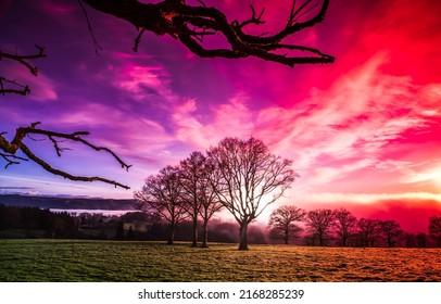 Bloody dawn over the field. Beautiful bloody dawn. Sunrise sky with bloody colors. Early morning nature at dawn