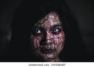 Bloody Halloween Makeup. Asian Woman With Blood Eye She Death And Scary With Blood Tear On Broken Face, Close Up Horror Bloodthirsty Ghost Female Fade Drop Out From Eyes, Happy Halloween Day Concept