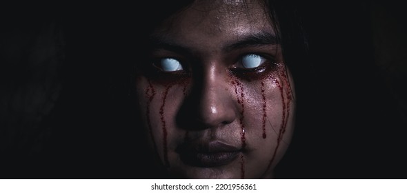 Bloody Halloween Makeup. Close Up Of Horror Bloodthirsty Ghost Female With Fade Drop Out From Eyes, Asian Woman With Blood Eye She Death And Scary With Blood Tear On Face, Happy Halloween Day Concept