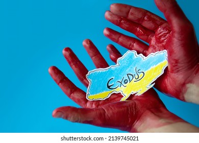 Bloody Hands On A Blue Background Holding A Paper Cutout Of The Map Of Ukraine Painted In The Colors Of Its Flag. Mass Exodus Of Civilian Citizens.