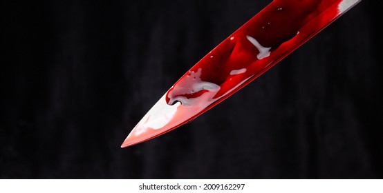 A Bloody Knife On A Black Background. The Concept Of Murder, Crime.