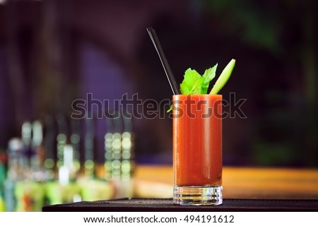 Bloody Mary at the bar counter. Classic cocktail. Dark background. Horizontal, lightly toned