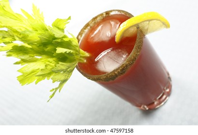 bloody or mary caesar drink with celery and ice cube. Shallow depth of field.