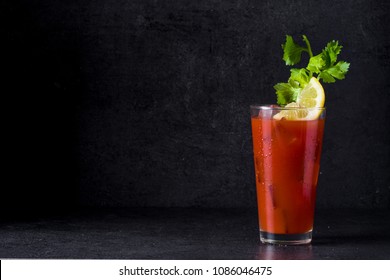 Bloody Mary cocktail in glass on black background. Copyspace