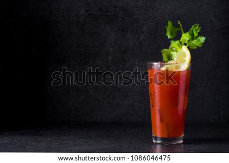 Bloody Mary cocktail in glass on black background. Copyspace