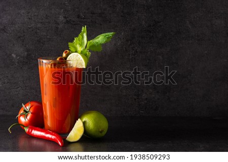 Bloody Mary cocktail in glass on black background.Copy space