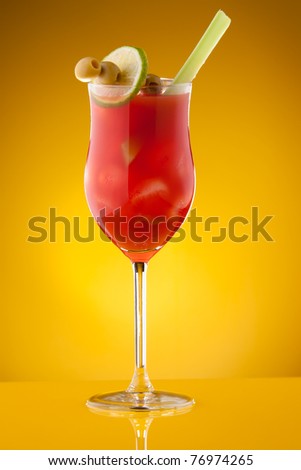 Bloody Mary cocktail with lemon, olives, and celery in glass