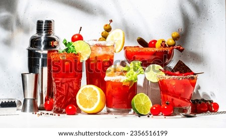 Bloody Mary, Joseph, Caesar and other cocktails variation with tomato juice, vodka, hot sauce and celery. Cocktail party. Gray background, hard light